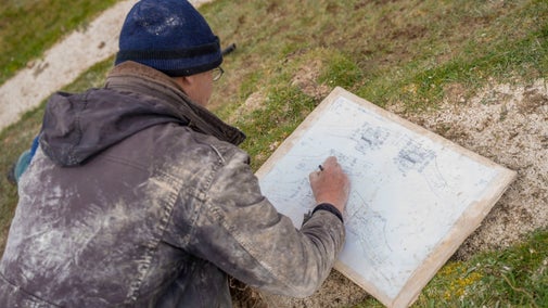 National Trust's Senior Archaeologist making site sketches during soil sampling